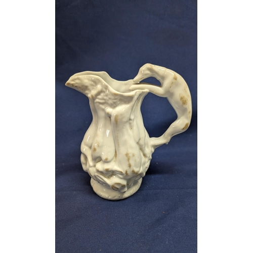 697 - Vintage White Porcelain Greyhound Handled Pitcher 14cm High with Body Depicting Game. Purchased at N... 