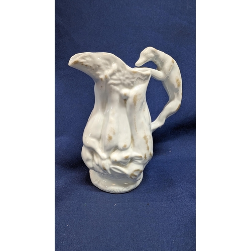 697 - Vintage White Porcelain Greyhound Handled Pitcher 14cm High with Body Depicting Game. Purchased at N... 