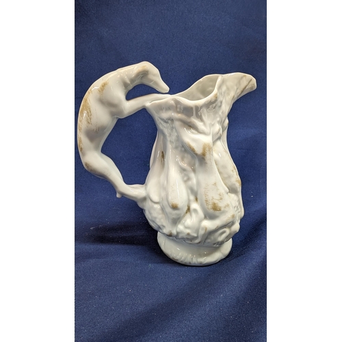 697 - Vintage White Porcelain Greyhound Handled Pitcher 14cm High with Body Depicting Game. Purchased at N... 