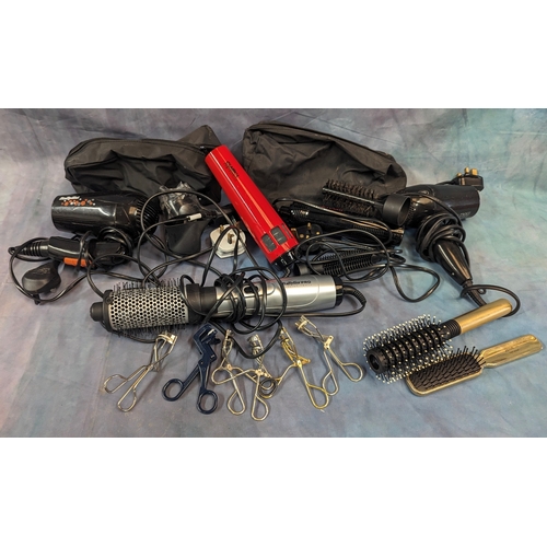 1069 - An assortment of Hair dryers, curlers, eyelash curlers and brushes