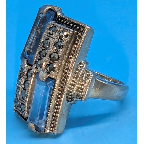 225 - An Art Deco Hallmarked silver and Marquisite ring with baguette cut blue topaz