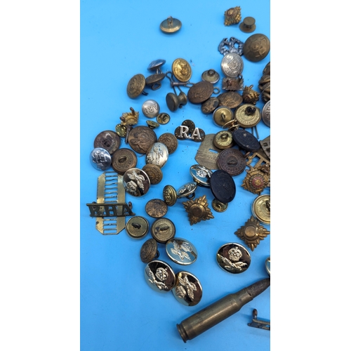 257 - A quantity of military badges and pips - mostly British, plus a Russian cap badge, deactivated bulle... 