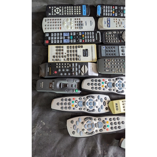 874 - Large selection of mixed remote controls.