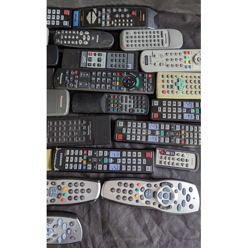 874 - Large selection of mixed remote controls.