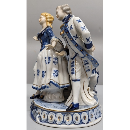 75 - A ceramic ornament of Regency figurines playing a piano - 23 x 28 x 15cm