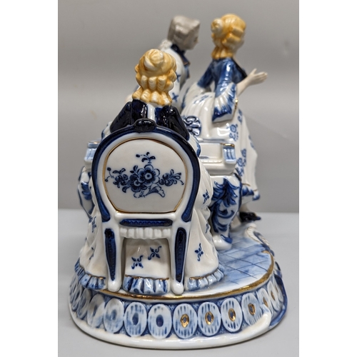 75 - A ceramic ornament of Regency figurines playing a piano - 23 x 28 x 15cm