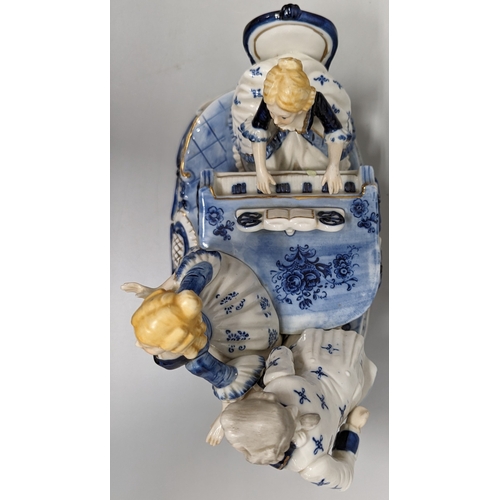 75 - A ceramic ornament of Regency figurines playing a piano - 23 x 28 x 15cm