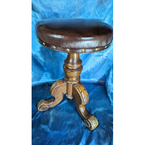 556 - Brown Leather topped stool on carved tripod legs