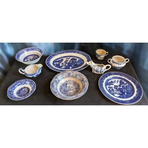 582 - A selection of Blue and White China with 'Old Willow' pattern, Colonial village and more