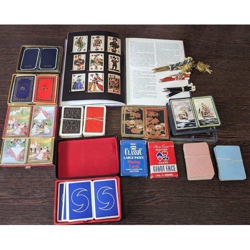 511 - A collection of assorted vintage playing cards and pencils - PLUS - 'Playing cards and their history... 