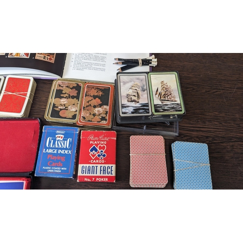 511 - A collection of assorted vintage playing cards and pencils - PLUS - 'Playing cards and their history... 