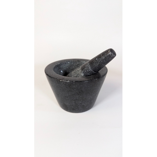 61 - A Black Granite Pestle and Mortar - 9cm x 13cm