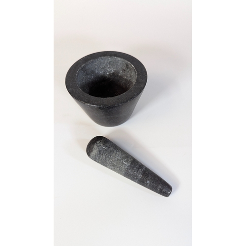 61 - A Black Granite Pestle and Mortar - 9cm x 13cm