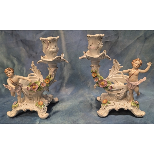 44 - A Pair of Sitzendorf Porcelain  Cherub Candle Sticks 18cm High, No visible chips or cracks