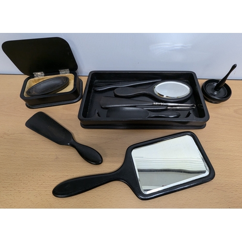 1050 - An Ebonised Dressing Table Set