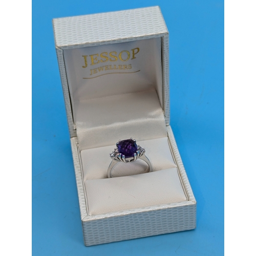 215 - An 18ct White Gold And Amethyst Ring With Diamond Accents To The Shoulders