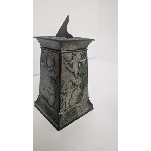 91 - Huntley and Palmer Biscuit Tin 1913 in the form of a Stone Column with Winged Cherubs, Bats and Bird... 