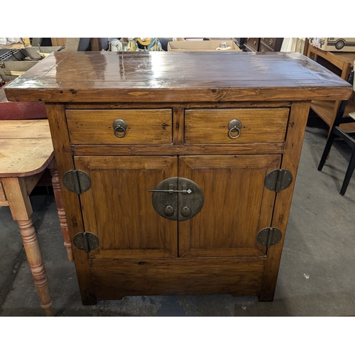 16 - .An Oriental Sideboard With Two Drawers