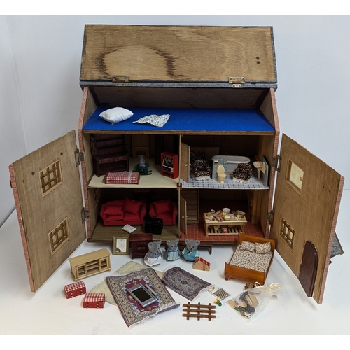 144 - A Dolls House with a Large Quantity of Furniture and accessories. 63.5cm Wide and 55cm High, 32cm De... 