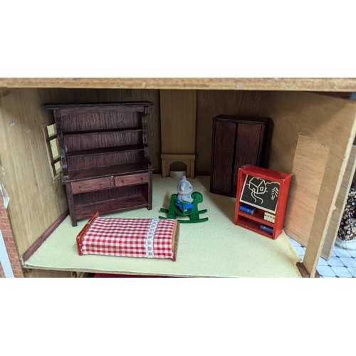 144 - A Dolls House with a Large Quantity of Furniture and accessories. 63.5cm Wide and 55cm High, 32cm De... 