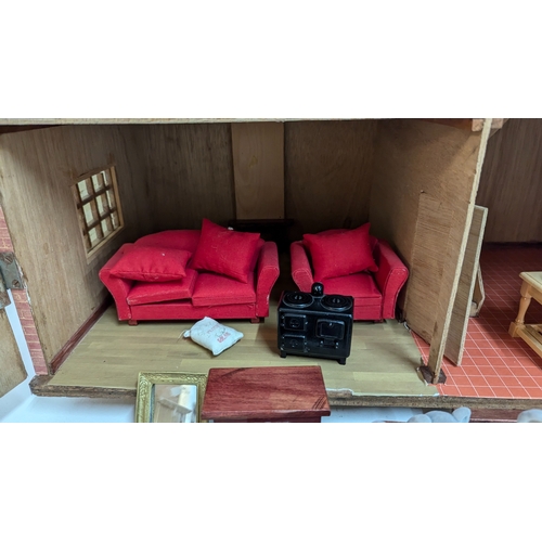 144 - A Dolls House with a Large Quantity of Furniture and accessories. 63.5cm Wide and 55cm High, 32cm De... 