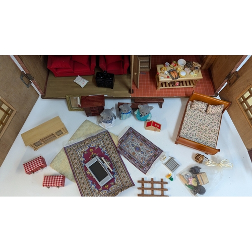 144 - A Dolls House with a Large Quantity of Furniture and accessories. 63.5cm Wide and 55cm High, 32cm De... 