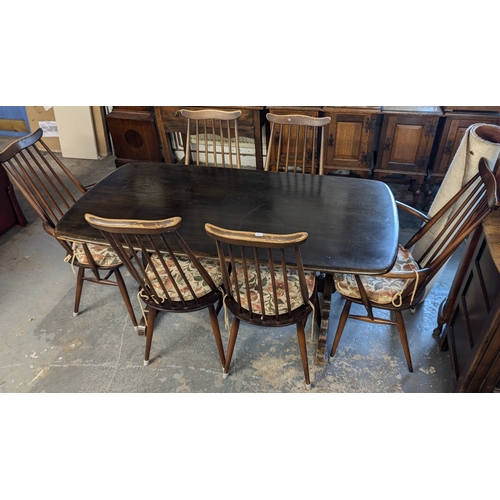 131 - An Ercol Dining Table And 6 Chairs - (2 Carvers)