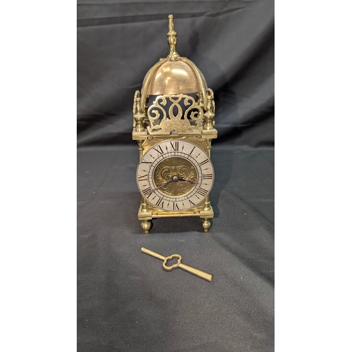 19 - A French Brass Lantern Clock with Key - Running 27cm Tall