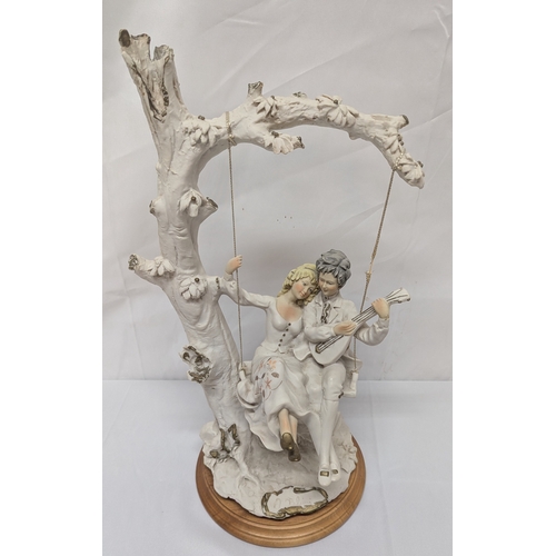 626 - .A Beleinca Porcelain Figure Of A Lady And Gentleman On A Swing - 43cm Tall