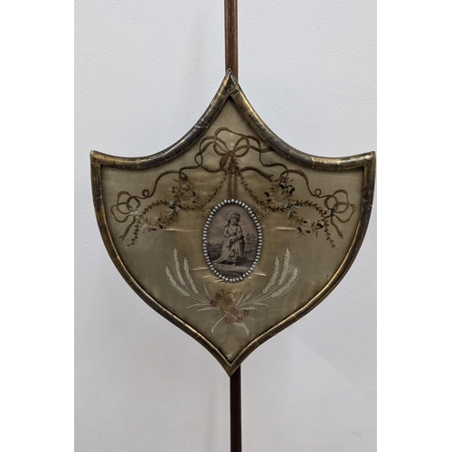 673 - .An Antique Mahogany Shield Pole Fire Screen