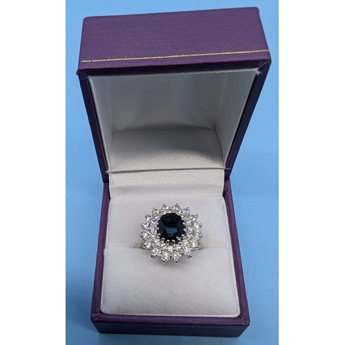 701 - A Sapphire And White Stone Cluster 9ct Gold Ring. Size N/O 5.08gms