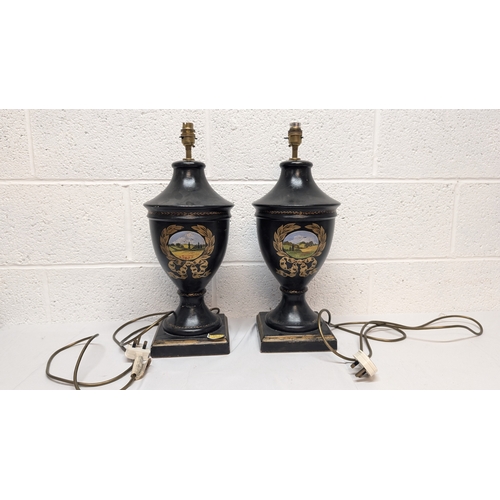 660 - A Pair of Antique Black Painted Urn Shaped Table Lamps Depicting Country Scenes 50cm Tall