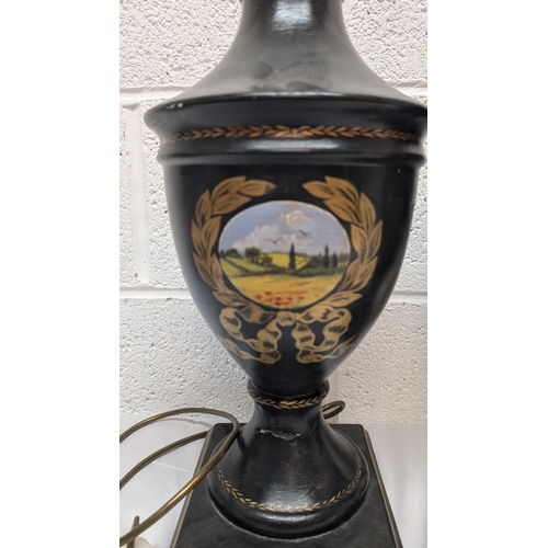 660 - A Pair of Antique Black Painted Urn Shaped Table Lamps Depicting Country Scenes 50cm Tall