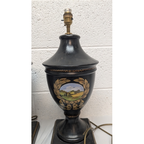 660 - A Pair of Antique Black Painted Urn Shaped Table Lamps Depicting Country Scenes 50cm Tall