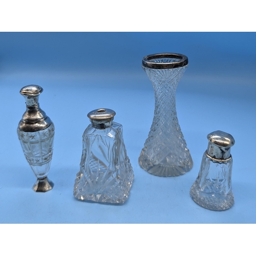 39 - An Assortment of Silver topped Cut Crystal Bottles and Vases