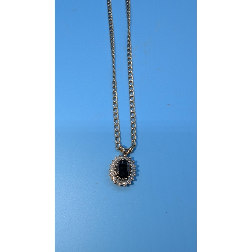 630 - A 9ct Gold and Sapphire 0.5ct Pendant Necklace Surrounded by Diamond Accents