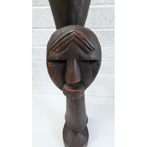 1024 - An African Tribal Drum With Carved Faces Standing 79cm High