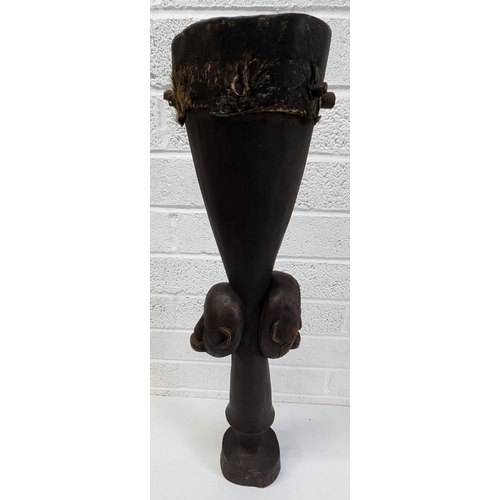 1024 - An African Tribal Drum With Carved Faces Standing 79cm High