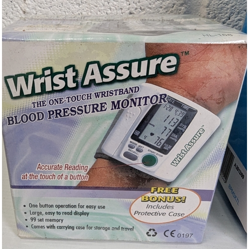 989 - A Pair Of Blood Pressure Monitors, A Kinetic Fully Automatic Blood Pressure Monitor, And A Wrist Ass... 