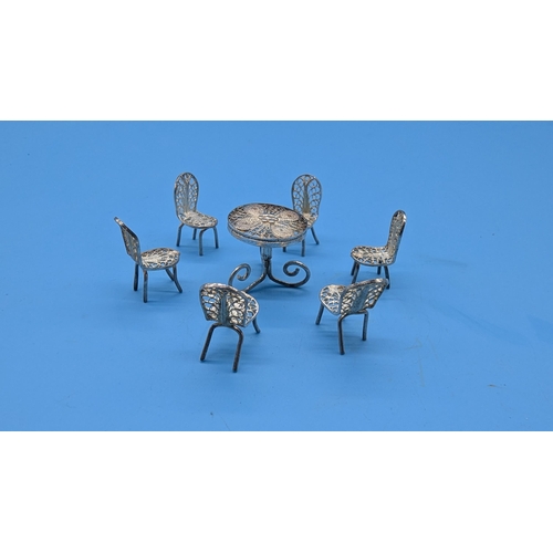 55 - A Filigree Silver Miniature Novelty Table and Chairs