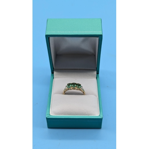 635 - A 9ct Emerald with Diamond Baguette to Shoulders Size M