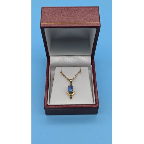 207 - An Opal and Diamond Pendant in 14ct Gold Setting on a 9ct Gold Chain