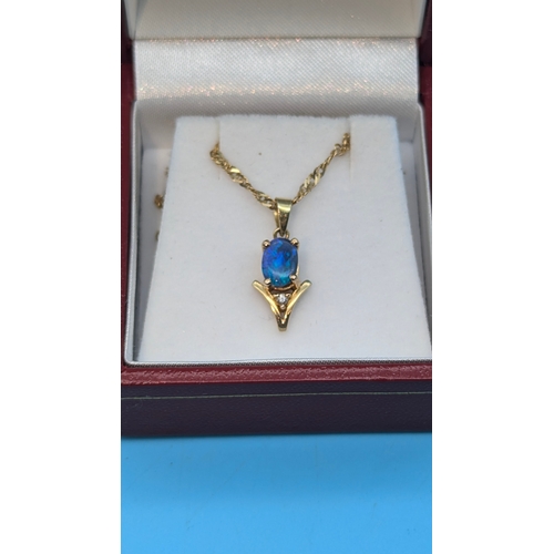 207 - An Opal and Diamond Pendant in 14ct Gold Setting on a 9ct Gold Chain