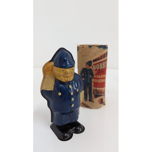 1003 - Vintage Tin Clockwork Toys, Bobby The Walking Policeman, A Soviet Matryoshka Doll and Wells Brimtoy ... 