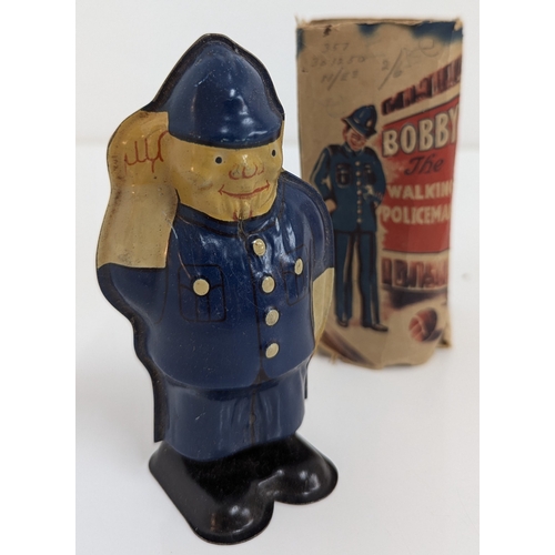 1003 - Vintage Tin Clockwork Toys, Bobby The Walking Policeman, A Soviet Matryoshka Doll and Wells Brimtoy ... 