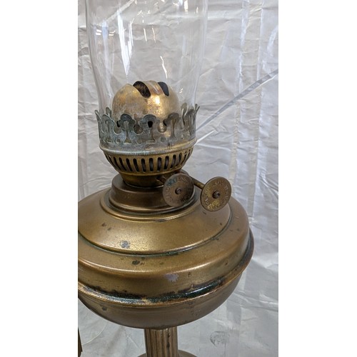 812 - A Brass Oil Lamp, Brass Wall Lamps, And Spare Chimney