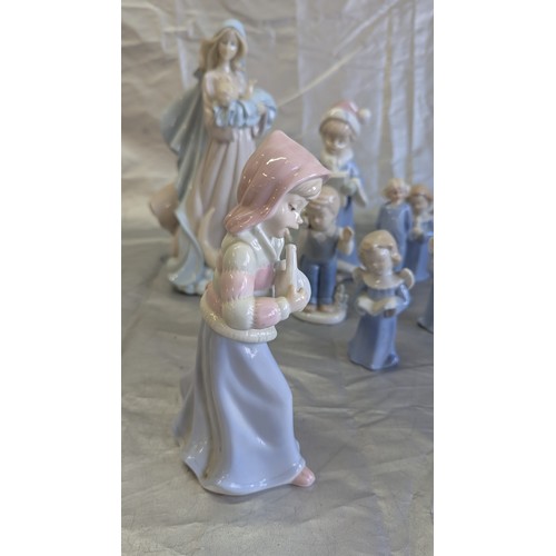 192 - A Collection of Nao Style Figurines x 9 inc . Angels, Religious Mother and Child, Girl with Clarinet... 