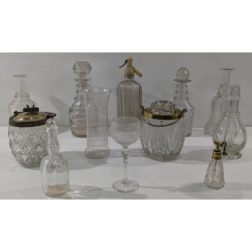 148 - A mixed lot of antique and vintage glassware, including cut and pressed glass decanters, bottles, ja... 