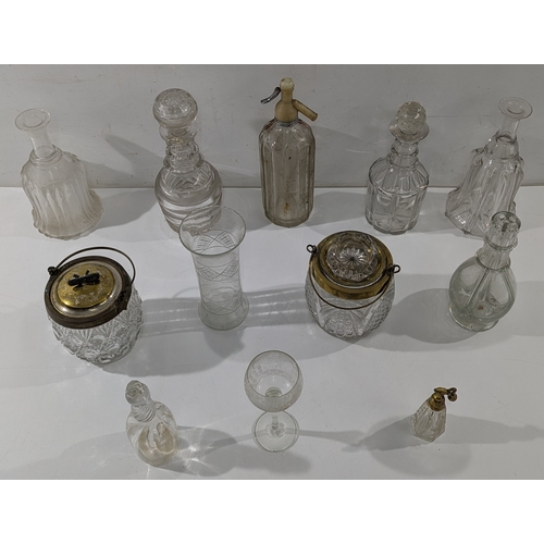 148 - A mixed lot of antique and vintage glassware, including cut and pressed glass decanters, bottles, ja... 