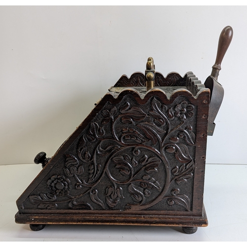 393 - Victorian Carved Coal Scuttle with Brass Mounts and Scoop

Victorian carved wooden coal scuttle of s... 